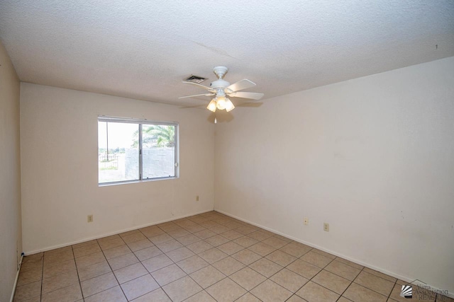 spare room featuring ceiling fan and a textured ceiling