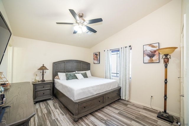 bedroom featuring wood-type flooring, vaulted ceiling, and ceiling fan