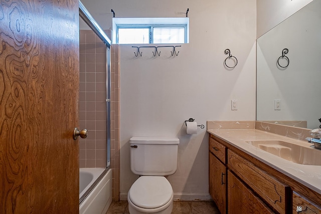 full bathroom featuring vanity, combined bath / shower with glass door, and toilet