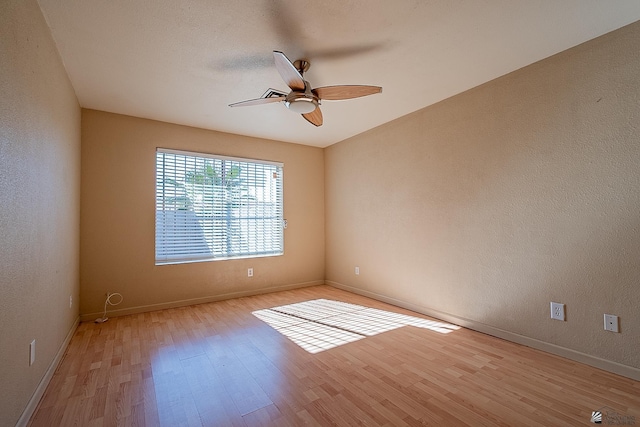 empty room featuring ceiling fan and light wood-type flooring