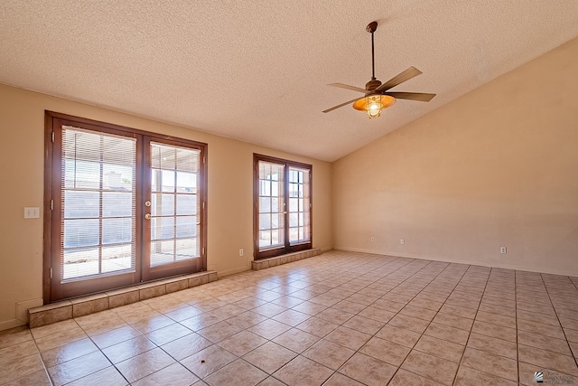 tiled empty room featuring a textured ceiling, vaulted ceiling, french doors, and ceiling fan