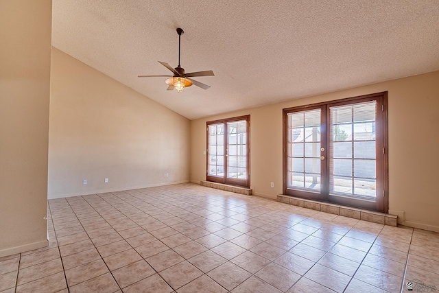 tiled spare room with french doors, ceiling fan, lofted ceiling, and a textured ceiling