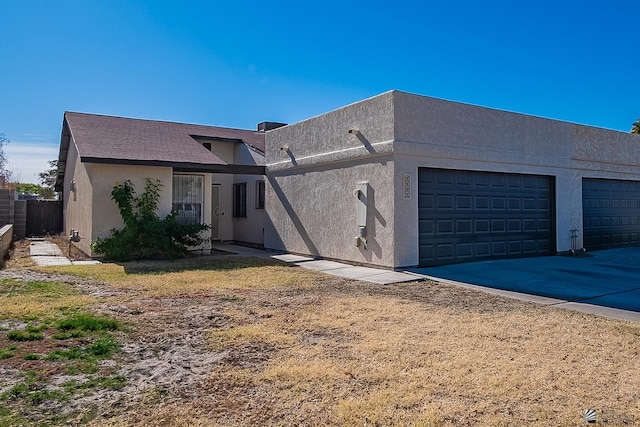 view of front of house featuring a garage and a front lawn