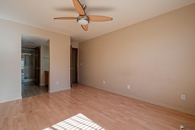 unfurnished bedroom with ceiling fan, ensuite bathroom, and light hardwood / wood-style floors