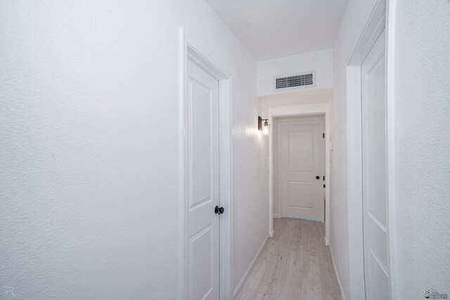 hallway with light hardwood / wood-style flooring