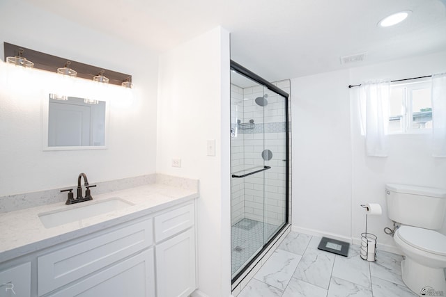 bathroom with a shower with door, vanity, and toilet