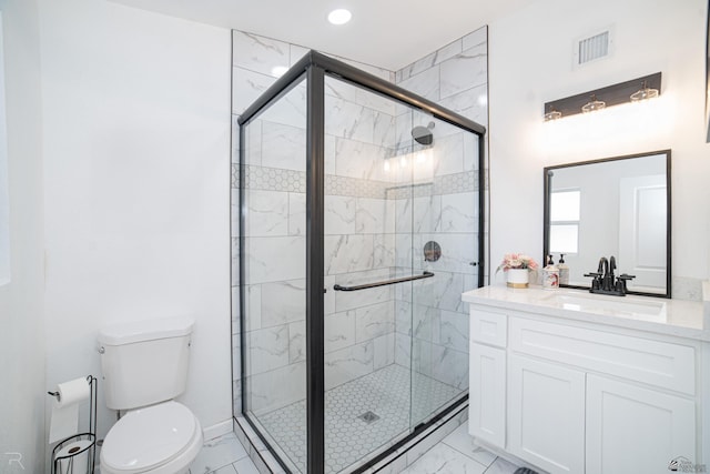 bathroom with vanity, toilet, and walk in shower