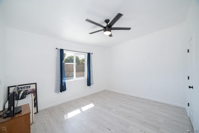 spare room with light hardwood / wood-style flooring and ceiling fan