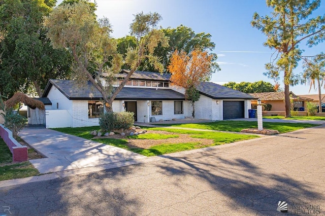 view of front of house with a garage and a front lawn