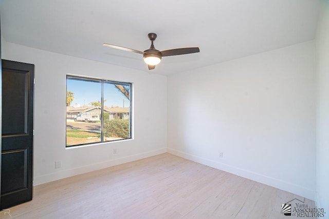 empty room featuring light wood-style floors, ceiling fan, and baseboards