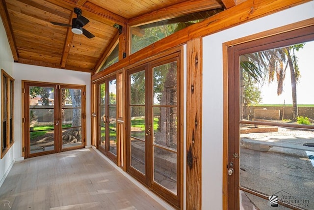 unfurnished sunroom with vaulted ceiling with beams, french doors, wood ceiling, and a ceiling fan