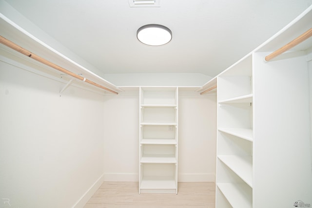 spacious closet featuring light wood-style flooring