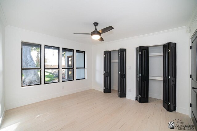 unfurnished living room with ceiling fan, light hardwood / wood-style floors, and lofted ceiling with skylight