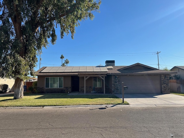 single story home featuring a garage, a front yard, and solar panels