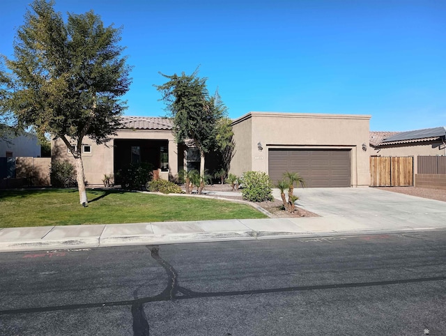 view of front of home with a garage and a front lawn