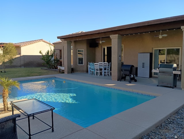 view of pool featuring ceiling fan, area for grilling, and a patio area