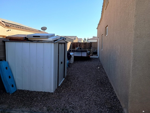 view of property exterior with a storage shed