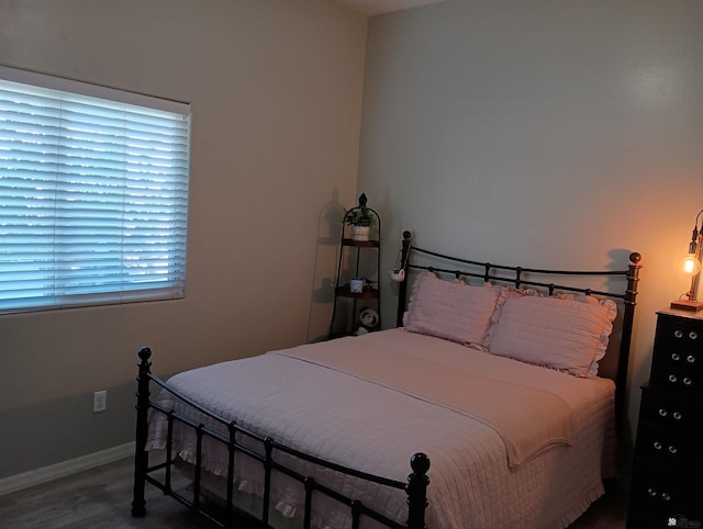 bedroom with dark wood-type flooring