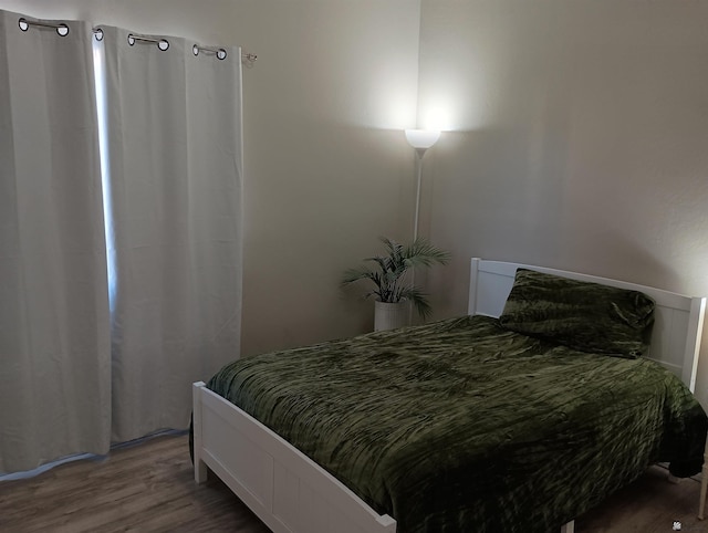 bedroom with wood-type flooring