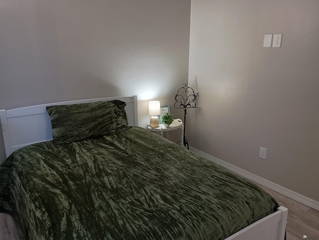 bedroom with hardwood / wood-style floors