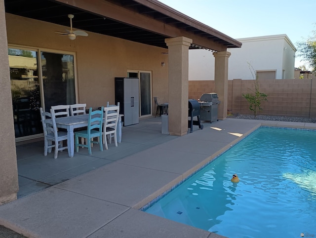 view of pool featuring area for grilling, ceiling fan, and a patio area