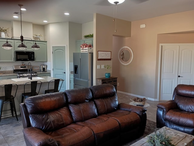 tiled living room featuring sink