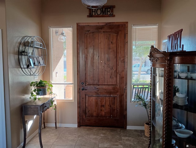 foyer featuring a wealth of natural light and light tile patterned flooring