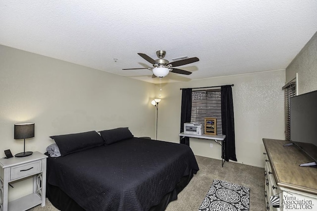 bedroom featuring visible vents, light colored carpet, a textured ceiling, and a ceiling fan