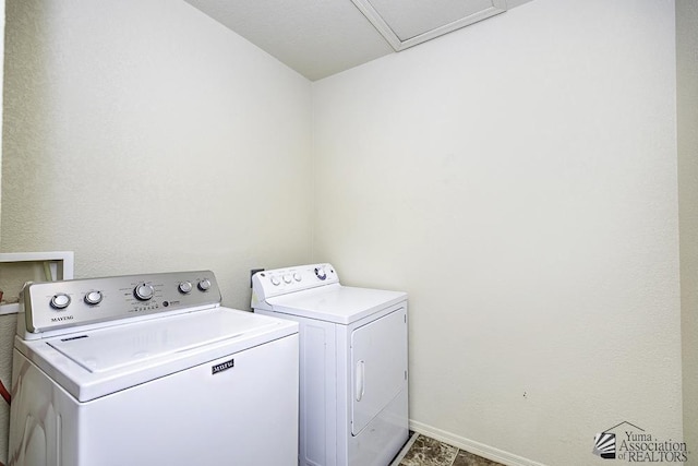 laundry room with washer and dryer, baseboards, and laundry area