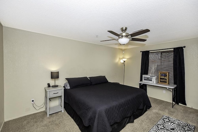 bedroom featuring carpet flooring, a textured ceiling, and a ceiling fan