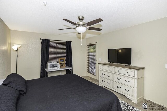 bedroom with a ceiling fan, baseboards, access to exterior, a textured ceiling, and light colored carpet