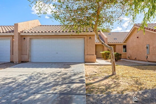 view of front of home featuring stucco siding, driveway, and an attached garage