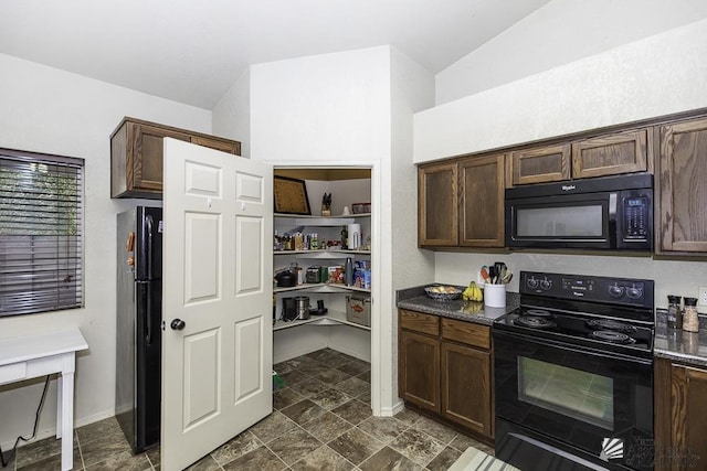 kitchen with dark brown cabinets, baseboards, dark countertops, and black appliances