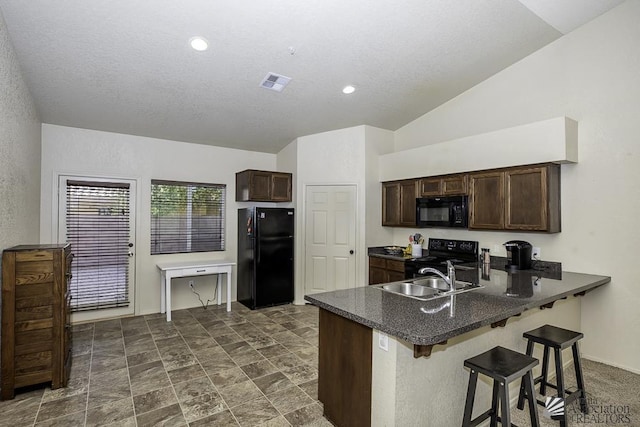 kitchen with visible vents, dark brown cabinetry, a peninsula, black appliances, and a sink