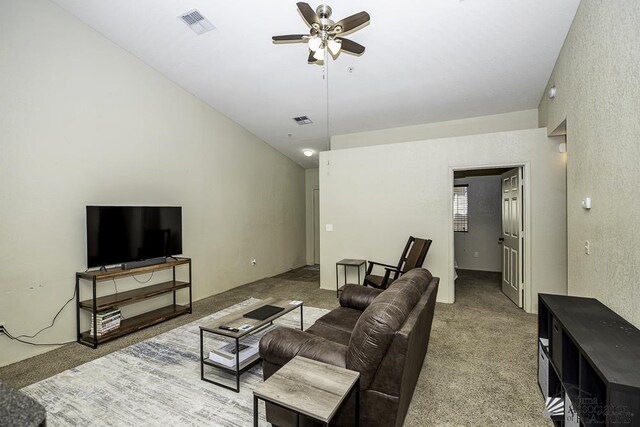 living room with visible vents, ceiling fan, and carpet flooring