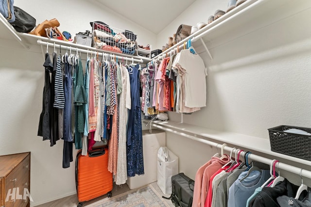 walk in closet with vaulted ceiling