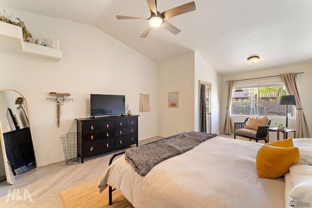 bedroom with ceiling fan, lofted ceiling, and light wood-type flooring