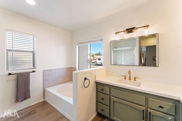 bathroom featuring vanity, hardwood / wood-style flooring, and separate shower and tub