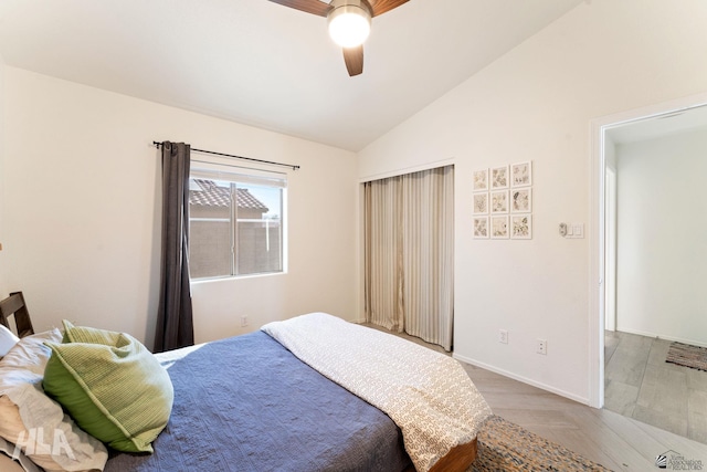 bedroom with ceiling fan, vaulted ceiling, and hardwood / wood-style floors