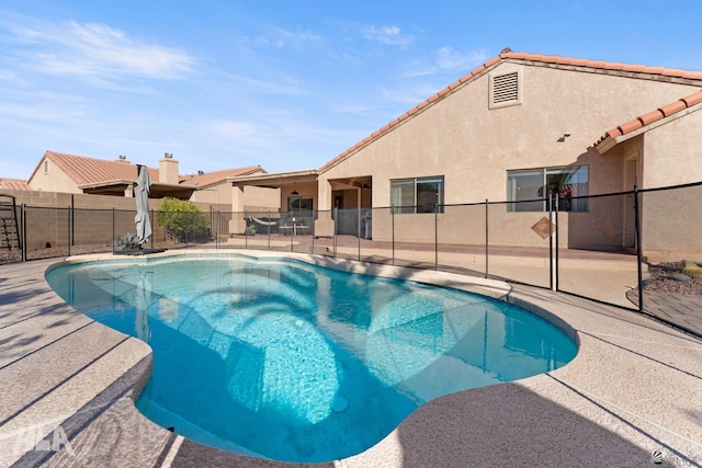 view of swimming pool featuring a patio area