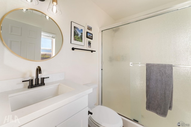 bathroom with vanity, toilet, and walk in shower