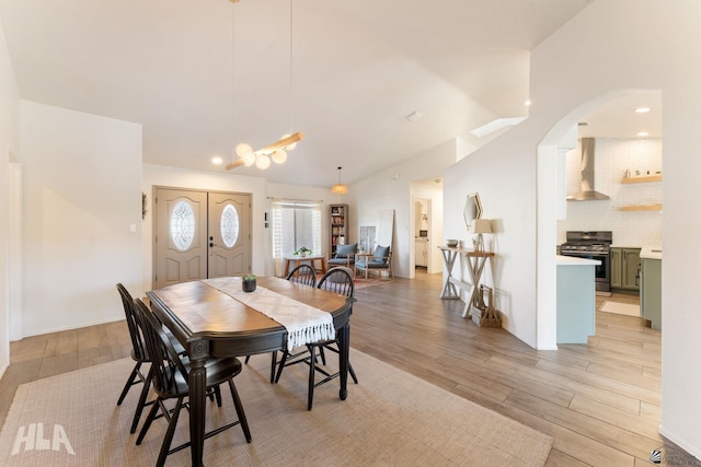 dining space featuring light hardwood / wood-style floors and vaulted ceiling