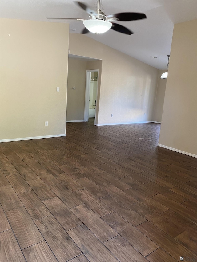 spare room with ceiling fan, dark hardwood / wood-style flooring, and vaulted ceiling