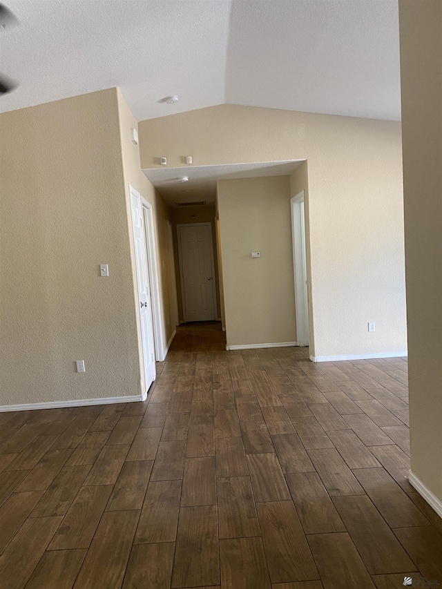 empty room with lofted ceiling