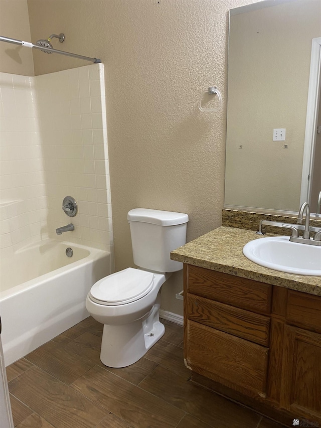 full bathroom featuring vanity, toilet, and washtub / shower combination