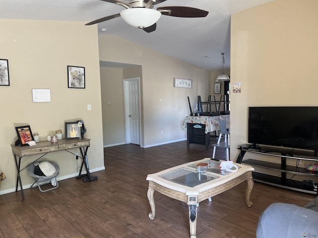 living room featuring dark hardwood / wood-style floors, ceiling fan, and vaulted ceiling