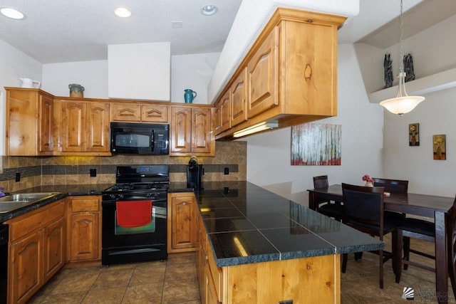 kitchen featuring tasteful backsplash, sink, black appliances, hanging light fixtures, and lofted ceiling