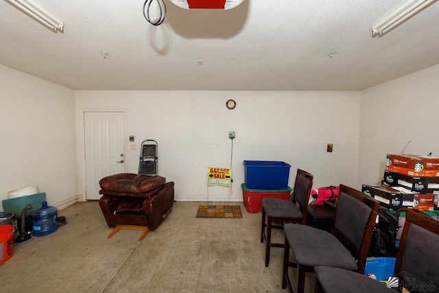 sitting room featuring concrete flooring