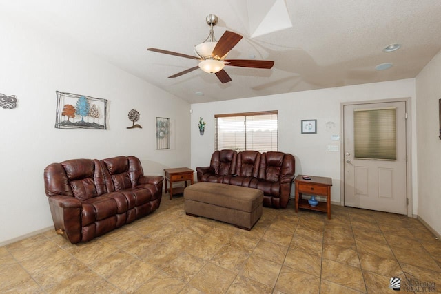 living room featuring a textured ceiling, ceiling fan, and lofted ceiling