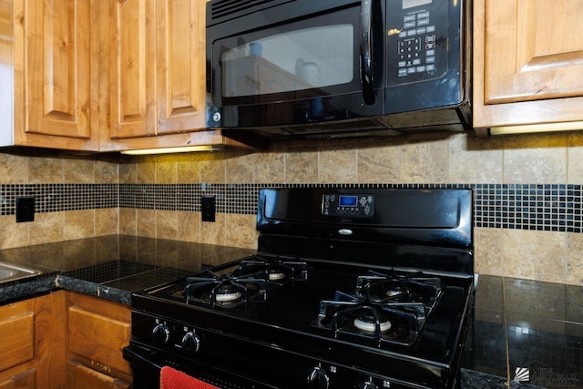 kitchen with tasteful backsplash and black appliances